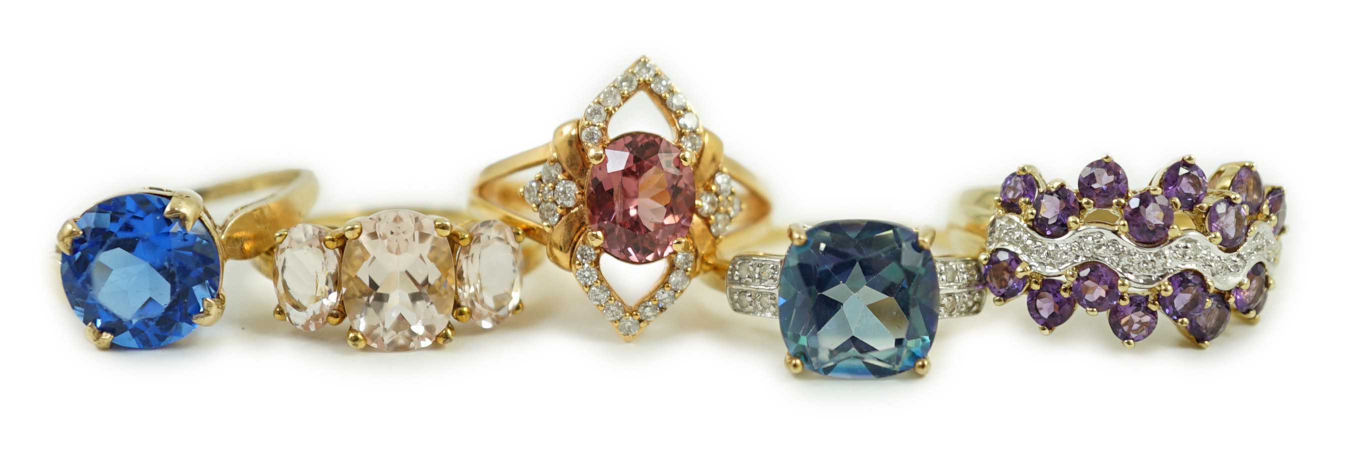 Four assorted modern 9ct gold and gem set rings and a similar 9k gem set ring, gross weight 16 grams.